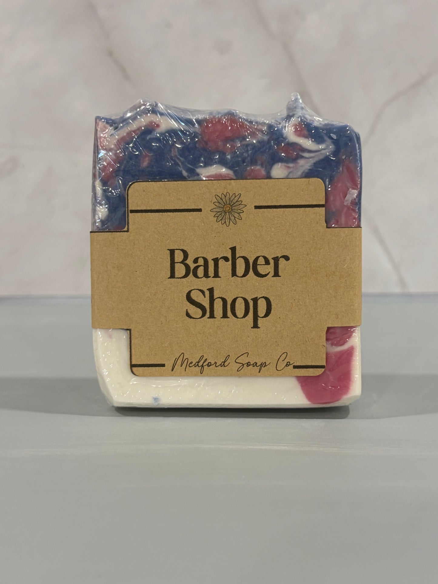 Bar of soap with 'Barber Shop' label on a gray background