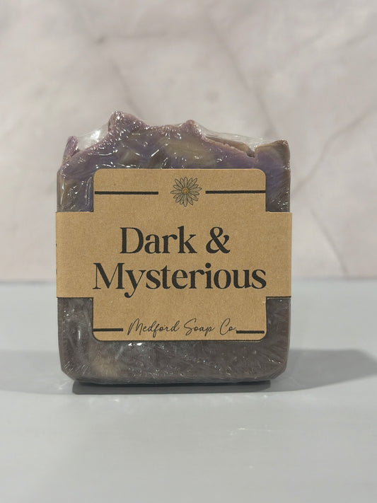 Bar of soap with a 'Dark & Mysterious' label on a white background