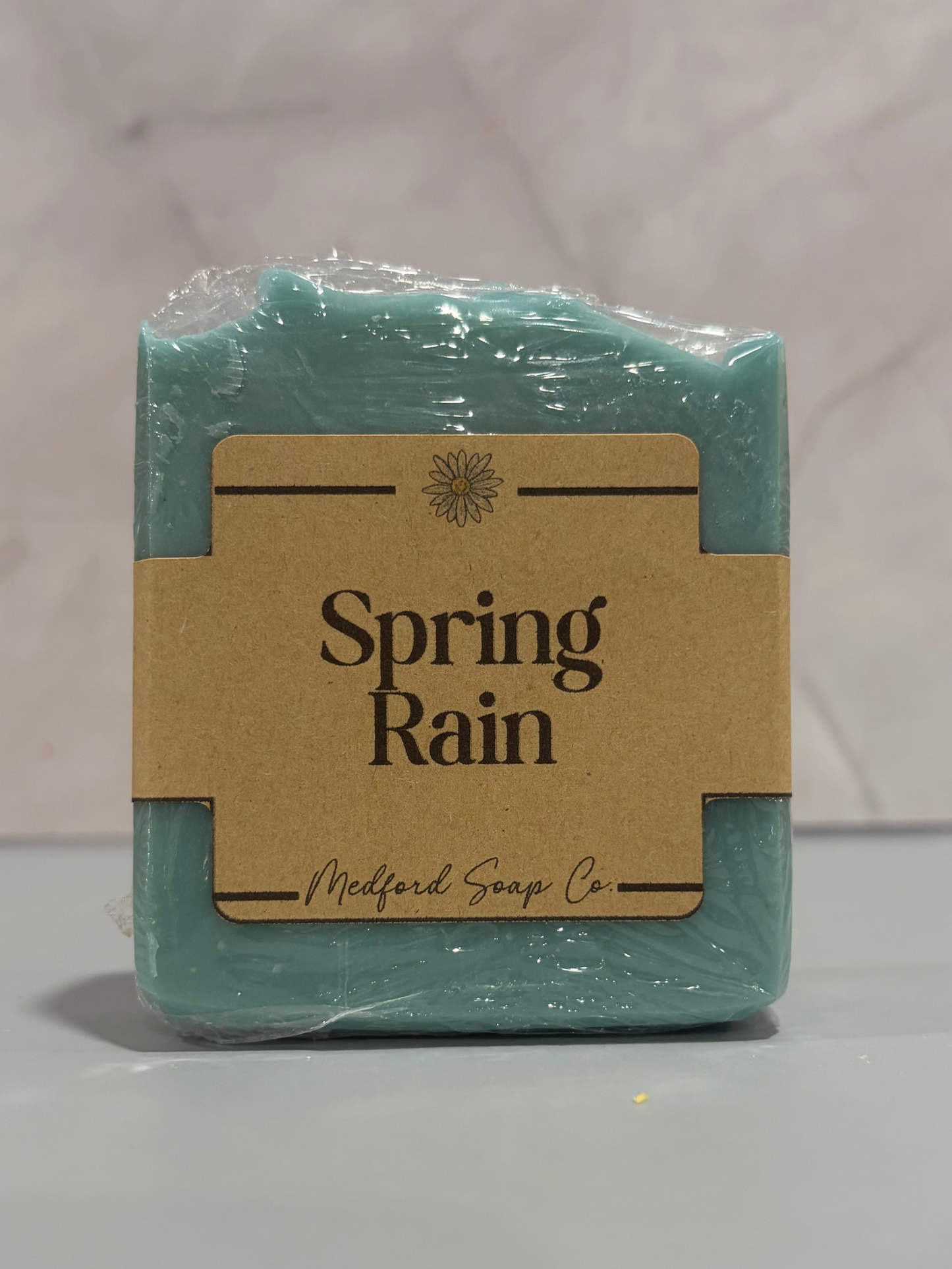 Bar of soap colored green/blue and scented like Spring Rain