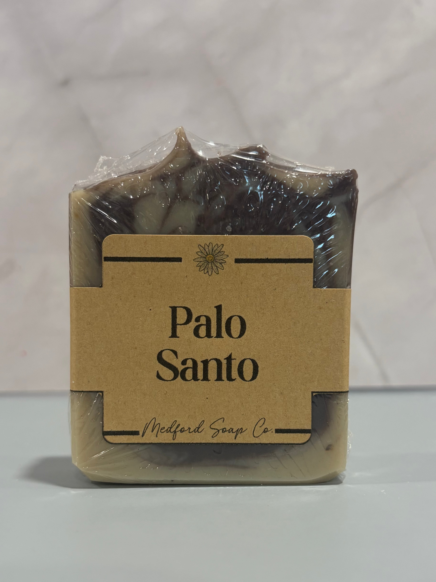 Bar of Palo Santo soap with a label on a white background