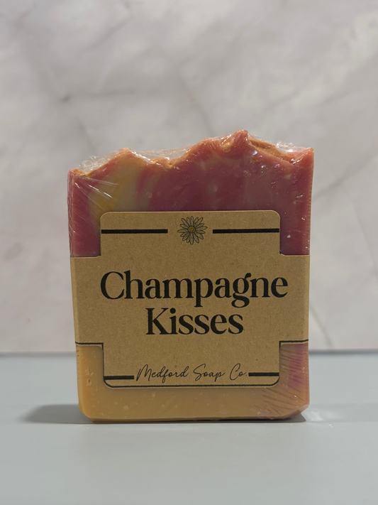 Bar of soap labeled 'Champagne Kisses' from Medford Soap Co. on a white background